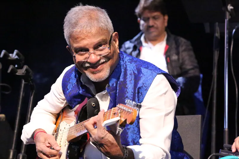 Guitarist smiling during a live set
