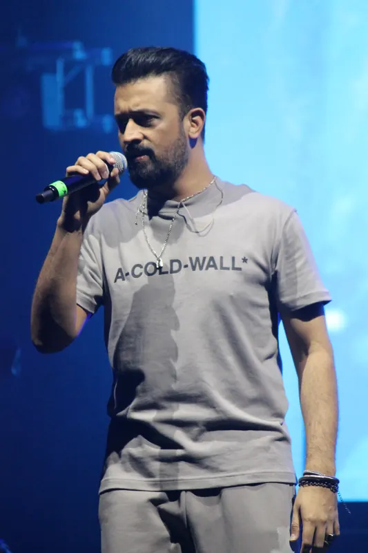 Singer performing under blue stage light
