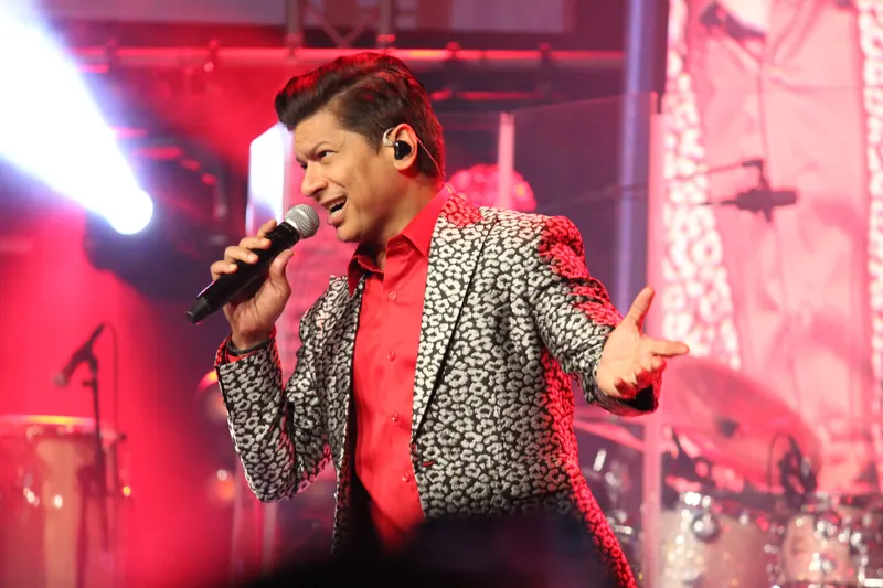 Vocalist mid-song under red stage light